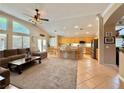 Open-concept living room with a cozy seating area, kitchen island with bar stools, and modern finishes at 2986 Matese Dr, Henderson, NV 89052