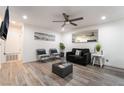 Bright living room features a ceiling fan, TV, and wood-style flooring at 3120 S Eastern Ave # 5, Las Vegas, NV 89169