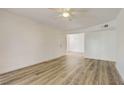 Spacious, sunlit living room with light wood-look floors and fresh paint, ready for personal touches at 3151 Soaring Gulls Dr # 2002, Las Vegas, NV 89128