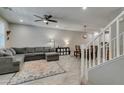 Open-concept living area with tile floors, a comfortable gray sectional sofa, and bright natural light at 3166 Via Da Vinci, Henderson, NV 89044