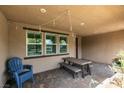 Covered outdoor patio with tile flooring, dining table set, and string lights, perfect for entertaining at 3166 Via Da Vinci, Henderson, NV 89044