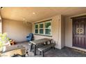 Relaxing covered outdoor patio featuring a dining table, brick flooring, and ambient string lights at 3166 Via Da Vinci, Henderson, NV 89044