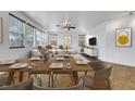 Formal dining area with large windows, modern furniture, and decor offers great space for entertaining at 3217 Palladio Ave, North Las Vegas, NV 89031