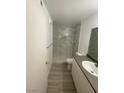 Bathroom featuring tile shower, shower niche, wood-look floors and vanity with sink at 3450 Erva St # 167, Las Vegas, NV 89117