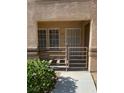 Ground-level entryway with security gate and window to the left of the front door at 3450 Erva St # 167, Las Vegas, NV 89117