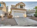 Inviting two-story home with a two-car garage and well-maintained desert landscaping in a residential area at 3525 Tuscany Village Dr, Las Vegas, NV 89129