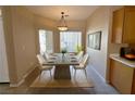 Bright dining room with modern table set, complemented by natural light from large windows at 3567 Cottage Stream Ct, Laughlin, NV 89029