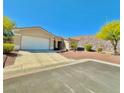 A well-maintained single-story home with desert landscaping and a two-car garage at 3567 Cottage Stream Ct, Laughlin, NV 89029