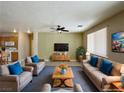 A spacious living room with comfortable seating, modern TV, and an open connection to the kitchen at 3567 Cottage Stream Ct, Laughlin, NV 89029