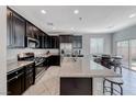 Modern kitchen features dark cabinetry, stainless steel appliances and granite countertops at 358 Badinerie St, Henderson, NV 89011