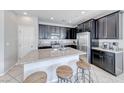 Modern kitchen features stainless steel appliances, granite countertops, and a breakfast bar at 358 Badinerie St, Henderson, NV 89011
