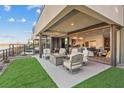 Back patio with comfortable seating around a fire pit, overlooking a beautiful lawn at 36 Lakefront Dr, Henderson, NV 89011