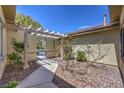 Private courtyard with stone groundcover, pergola, and gated entryway at 3636 Chelsea Gardens Dr, Las Vegas, NV 89135