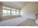 Spacious living room featuring large windows and neutral carpet at 3636 Chelsea Gardens Dr, Las Vegas, NV 89135