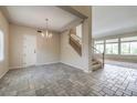 Open-concept living space featuring beautiful stone floors and stairway at 3636 Chelsea Gardens Dr, Las Vegas, NV 89135