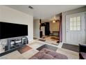 Inviting living room featuring tile floors, neutral paint, and access to the kitchen at 3924 Blackford Pl, Las Vegas, NV 89102