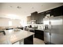 Bright kitchen with stainless steel appliances, granite counters and center island at 4465 Shimmering Skies St # 2180, North Las Vegas, NV 89031