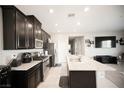 This kitchen features dark cabinets, stainless appliances, and a large island at 4465 Shimmering Skies St # 2180, North Las Vegas, NV 89031