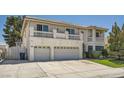 A well maintained two story home with a three car garage and green lawn at 4504 Dunlap Crossing St, Las Vegas, NV 89129