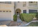 Arched covered entry to home with lush greenery, attached garage on left at 4504 Dunlap Crossing St, Las Vegas, NV 89129