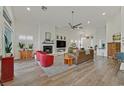 Bright living room with a fireplace, ceiling fan, and wood laminate flooring at 512 Pima Canyon Ct, Las Vegas, NV 89144