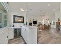 Bright and airy open floor plan, wet bar, fireplace, and wood laminate floors at 512 Pima Canyon Ct, Las Vegas, NV 89144