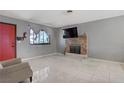 Living room with fireplace, tile floors and window providing natural light at 5463 Waltham Ln, Las Vegas, NV 89122
