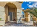 Close-up of the elegant front entry featuring a brick walkway, stucco columns, and a stylish arched doorway at 5790 Douglas Everett St, Las Vegas, NV 89120