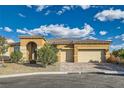 Beautiful home with a brick driveway and 2-car garage, complemented by manicured landscaping and a welcoming arched entrance at 5790 Douglas Everett St, Las Vegas, NV 89120