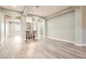 Spacious living area with sleek flooring, a stylish bar area, recessed lighting, and an open-concept design at 5790 Douglas Everett St, Las Vegas, NV 89120