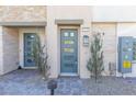 Stylish townhome entrance with modern blue door and stone accents at 600 N Carriage Hill Dr # 2098, Las Vegas, NV 89138