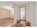 Bright entryway featuring a large mirror, hardwood floors, a chandelier, and neutral wall colors at 6417 Giant Oak St, North Las Vegas, NV 89084