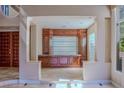 Elegant entertaining area with custom bar, marble floors, and bright natural light at 7969 Bermuda Dunes Ave, Las Vegas, NV 89113