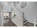 Inviting foyer featuring a staircase, hardwood floors, neutral walls, and elegant decor elements at 8039 Baldy Mountain Ave, Las Vegas, NV 89131