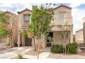 Charming two-story home with a well-maintained lawn and a private two car garage at 9100 Balcony Trellis Ave, Las Vegas, NV 89149