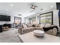 A modern living room with stylish furniture, neutral tones, and natural light from large windows, creating an inviting space at 9565 Camelback Creek Dr, Las Vegas, NV 89178
