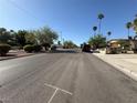 Wide street view showing the neighborhood with mature trees, well-maintained landscaping, and clear blue skies at , Las Vegas, NV 89121