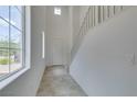 Bright entryway with tile flooring, high ceilings, a staircase and large windows at 1004 Huckburn Ave, Henderson, NV 89015