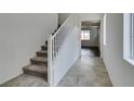 Bright staircase with carpeted steps and white railing, leading to the upper level of the home at 1004 Huckburn Ave, Henderson, NV 89015