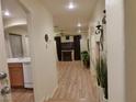Bright hallway featuring stylish light fixtures and an open view to the living area at 10360 Lettuce Leaf St, Las Vegas, NV 89183