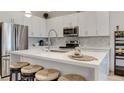 Bright kitchen featuring stainless steel appliances, white countertops, and bar stool seating with modern fixtures at 11485 Vibrant Heights Dr # 32, Las Vegas, NV 89135