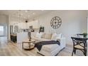 Open-concept living space with a comfortable sofa, kitchen island, and stylish decor at 11485 Vibrant Heights Dr # 32, Las Vegas, NV 89135