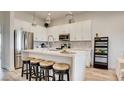 Modern kitchen with white cabinets, stainless steel appliances, and a center island with seating at 1164 Prospering Creek St, Las Vegas, NV 89135