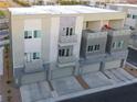 Three-story townhome with individual garages, neutral tones, and private balcony for outdoor living at 1181 Blossom Point St, Las Vegas, NV 89135