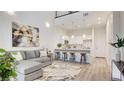 Open floor plan showcasing a kitchen with bar seating and comfortable living room at 1187 Blossom Point St # 36, Las Vegas, NV 89135