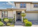 Charming entrance to a two-story home with a stone facade and well-manicured landscaping at 12311 Middle Creek St, Las Vegas, NV 89138