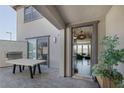 Stylish outdoor patio featuring an outdoor fireplace, dining area, and seamless indoor/outdoor living at 12311 Middle Creek St, Las Vegas, NV 89138