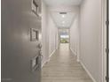 Bright hallway with wood flooring, recessed lighting, and neutral walls leading into an open floorplan at 12550 Point Sierra St, Las Vegas, NV 89138