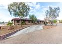 Inviting single-story home featuring desert landscaping, and a long driveway at 1500 Tumbleweed Dr, Henderson, NV 89002
