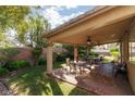 Relaxing covered patio with an outdoor dining set, perfect for entertaining in the backyard at 240 Jumping Springs Pl, Henderson, NV 89012